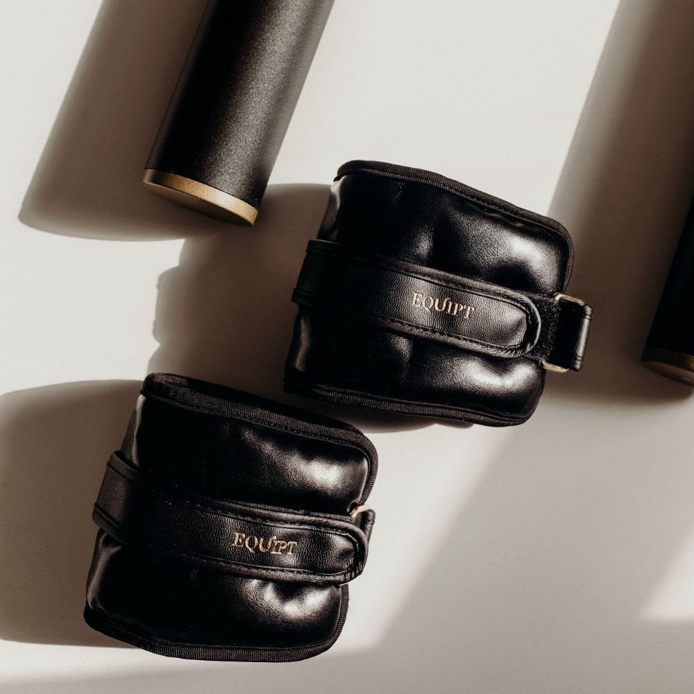 Uwraps weighted ankle and wrist wraps in black, perfect for adding extra resistance during workouts to burn more calories and tone muscles.