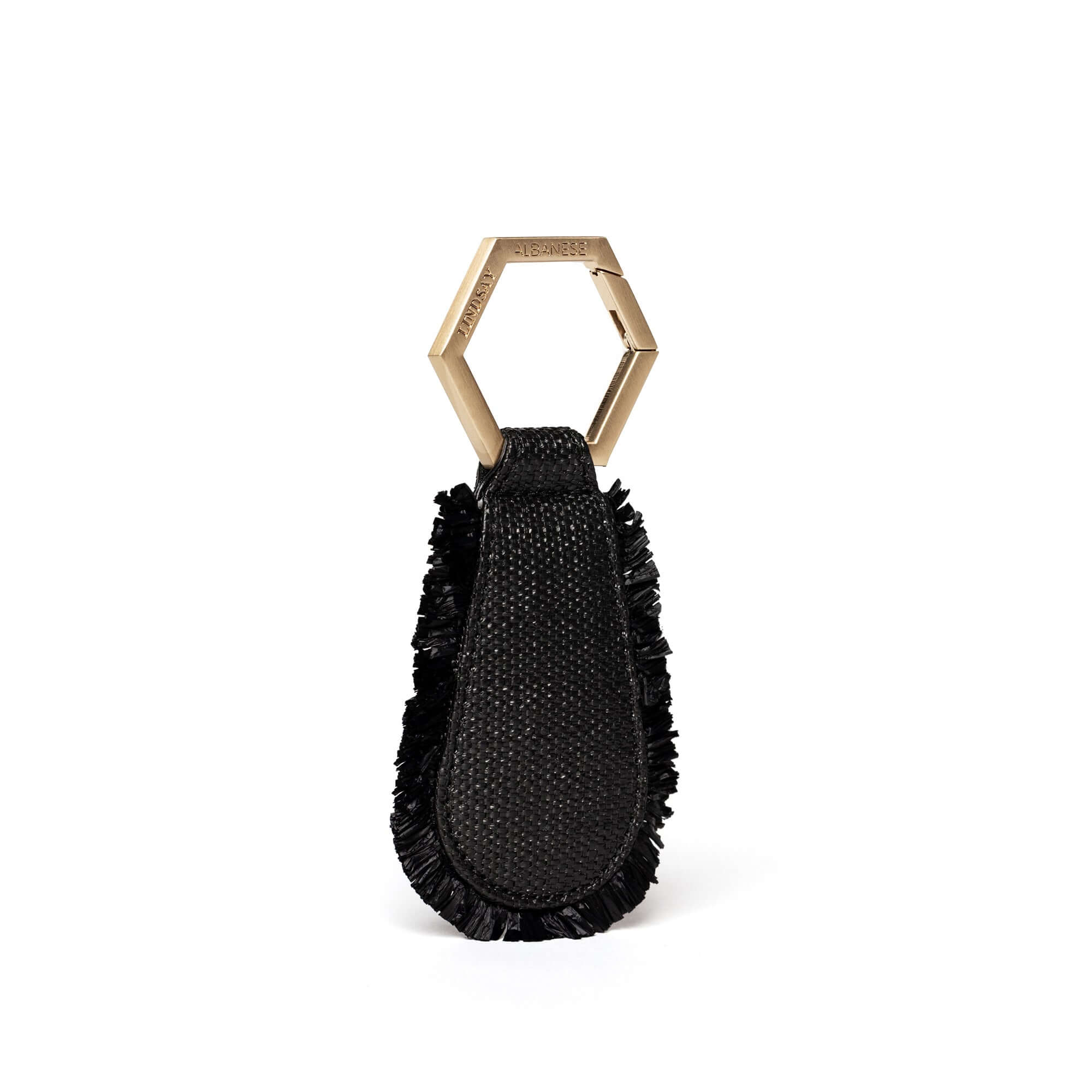 The fray raffia TOPTOTE magnetic hat clip attaches to your bag and allows you to travel with your hat hands free.