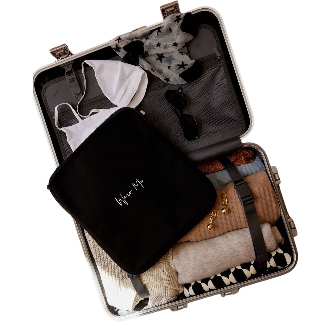 Two-sided travel laundry bag in a packed suitcase for organized clothing separation
