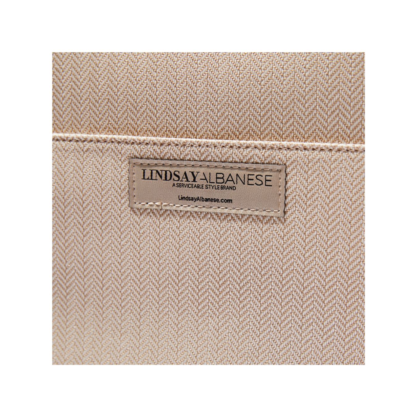 Closeup of brand tag Beige Laptop Clutch by Lindsay Albanese in collaboration with fabfitfun.