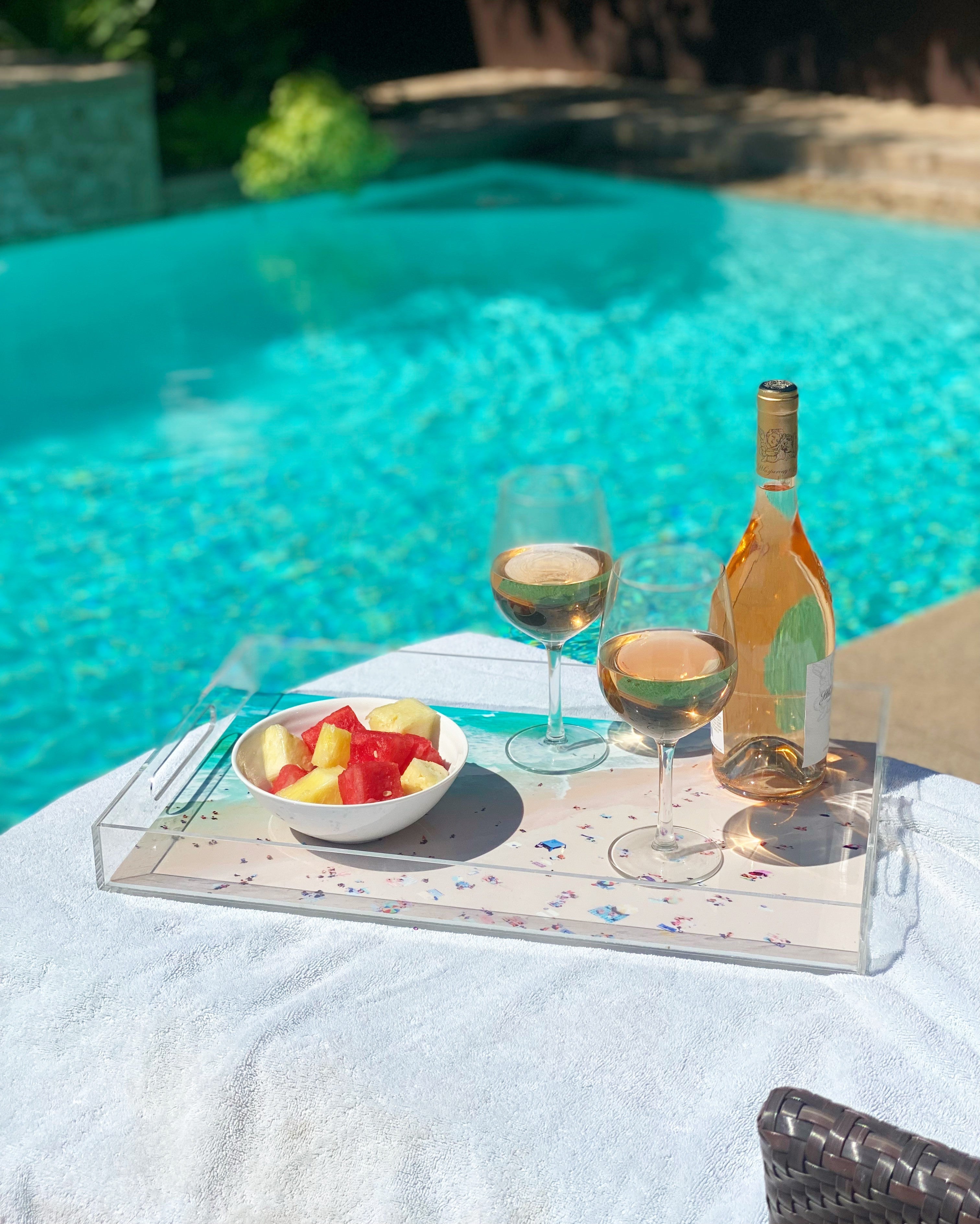 Statement Home clear acrylic serving tray with fruit and wine by the pool