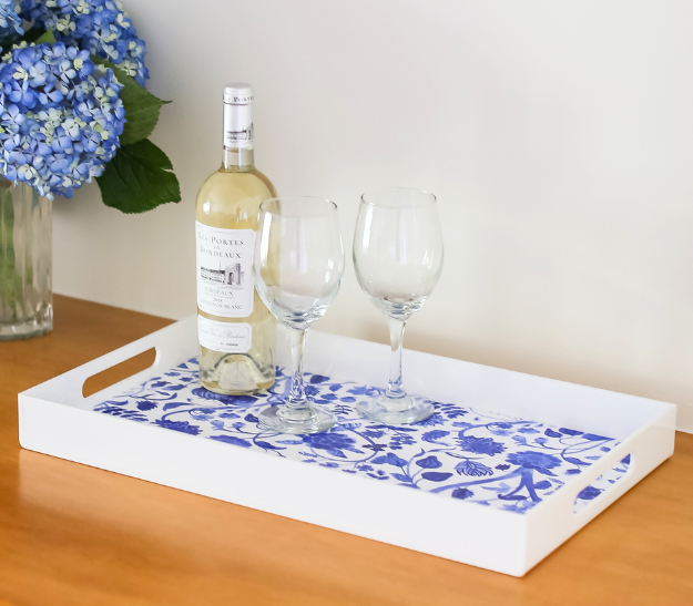 Statement Home white acrylic serving tray with insert with wine bottle and glasses.