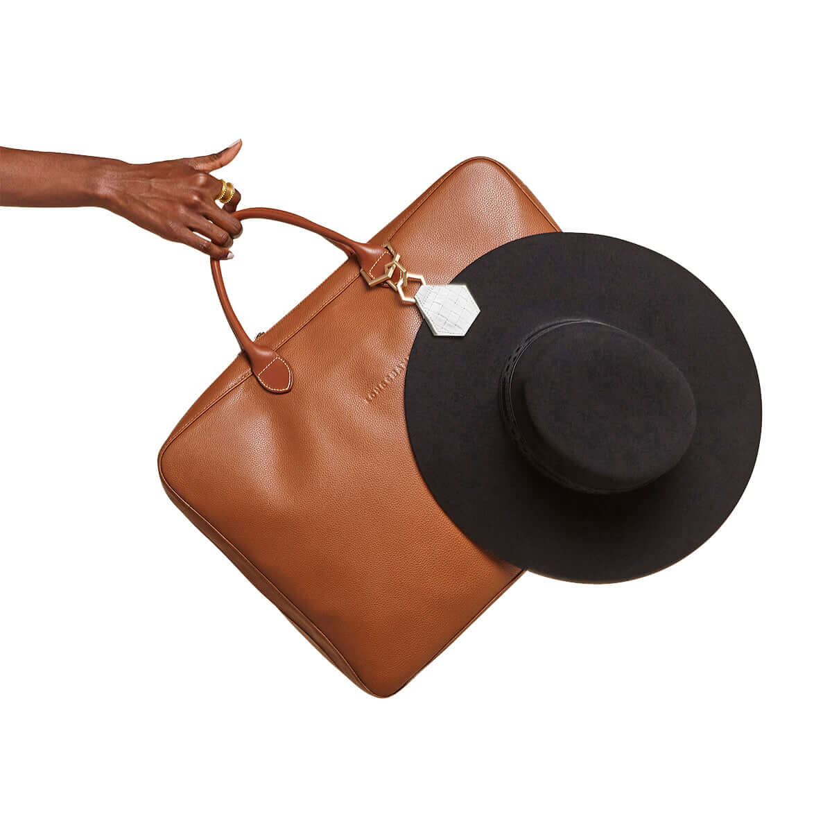 TOPTOTE by Lindsay Albanese magnetic hex hat clip with gold hardware and genuine leather attached to black felt hat