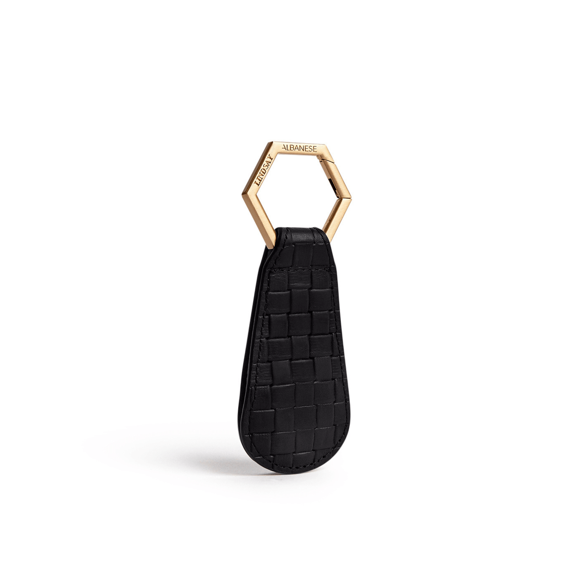 The Drop TOPTOTE hat clip in black with gold hexagonal ring for hands-free hat carrying