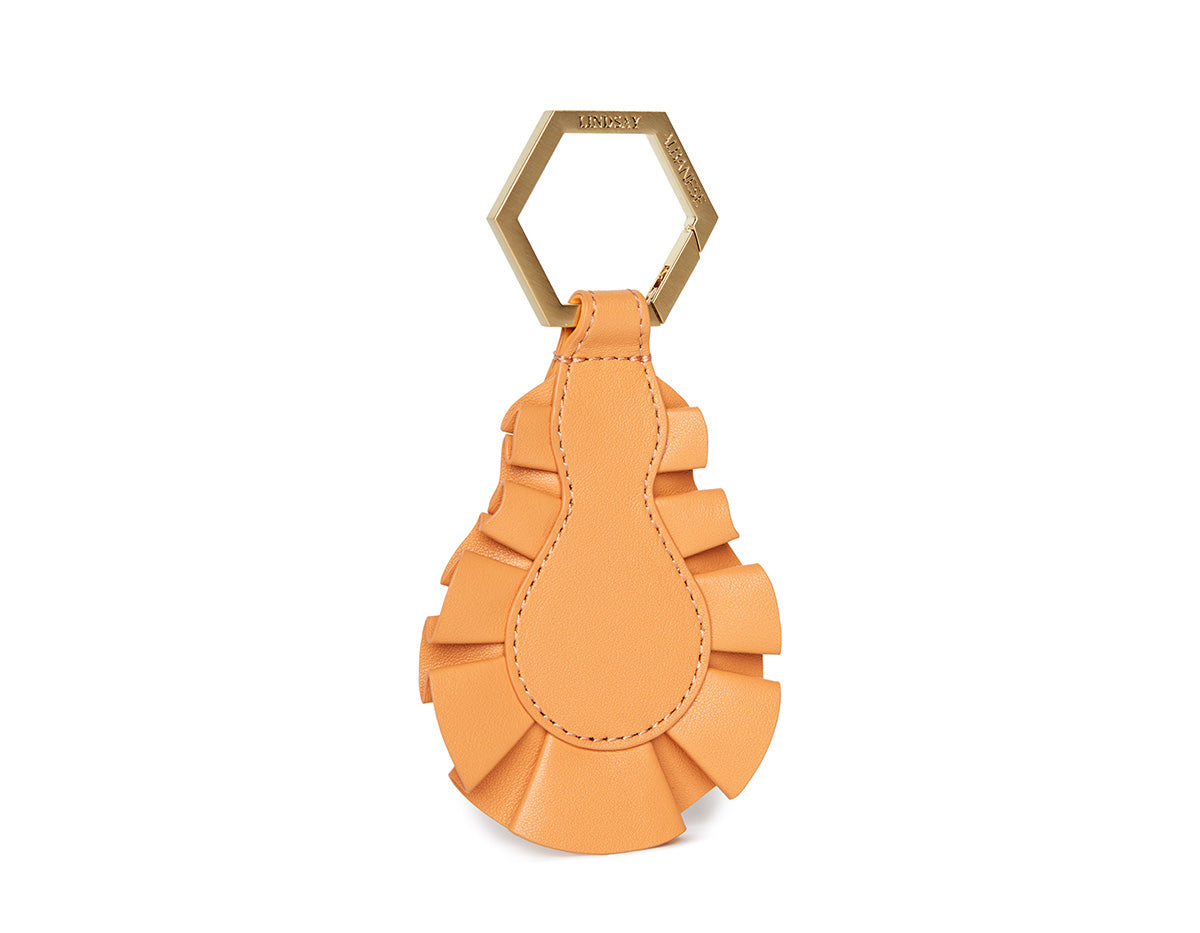 The Figure TOPTOTE in light orange with brushed gold hexagon hardware perfect for Spring collection and holding or adorning hats.